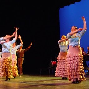 dancers in ruffled skirts onstage