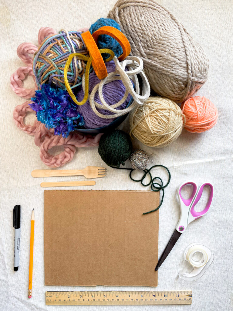 A photograph of all of the materials you will need to complete the activity: yarn, ribbon, pencil, marker, scissors, tape, ruler, and a fork or popsicle stick.